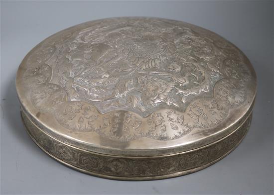 A Persian white metal circular box and cover, embossed with animals and birds, 31.5cm.